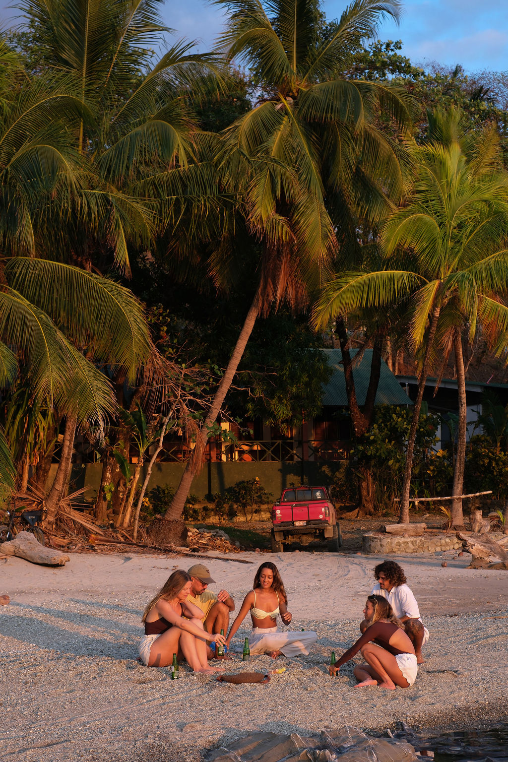 Group of friends watching the sunset on a Costa Rican beach